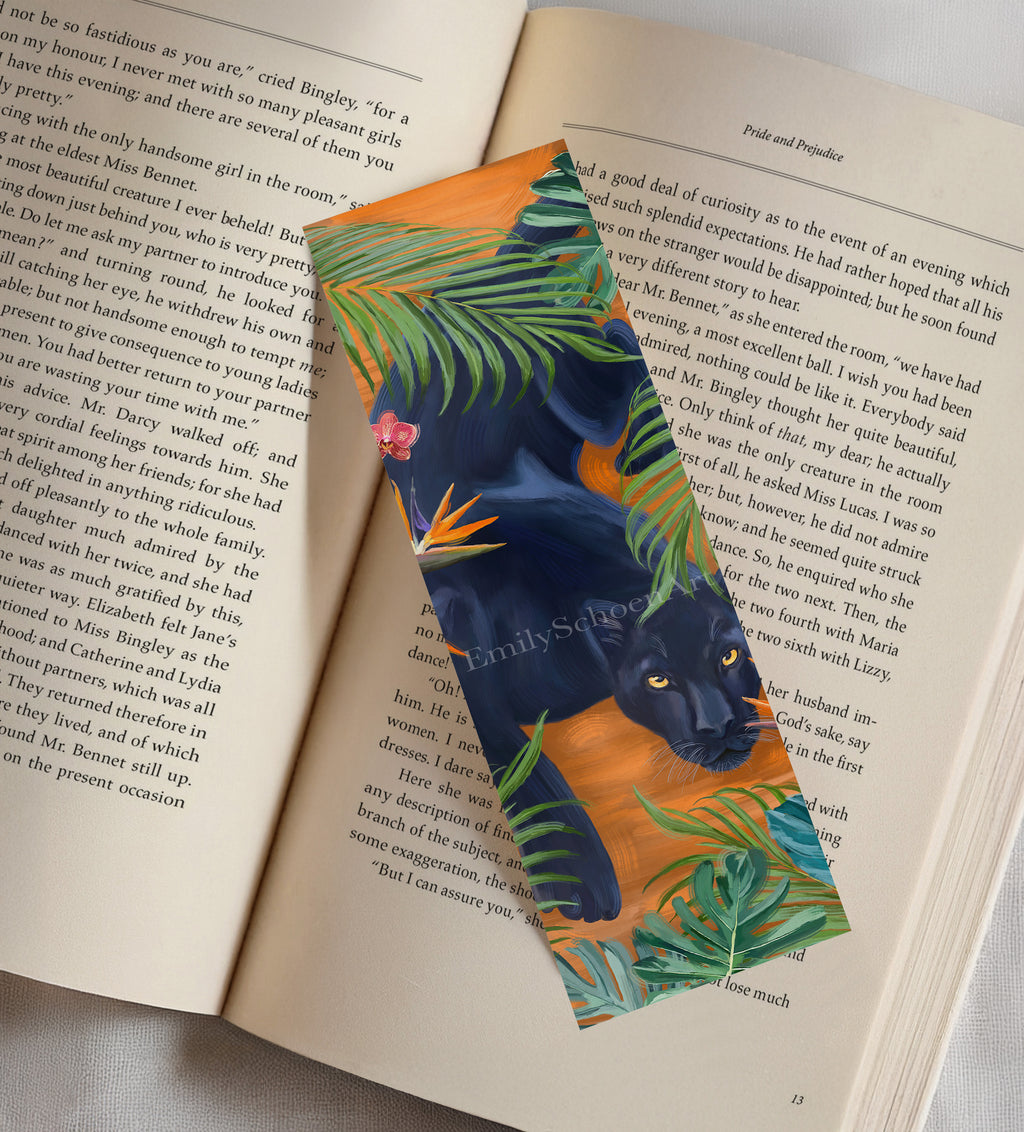 Colorful bookmark with a panther and tropical leaves design on an open book
