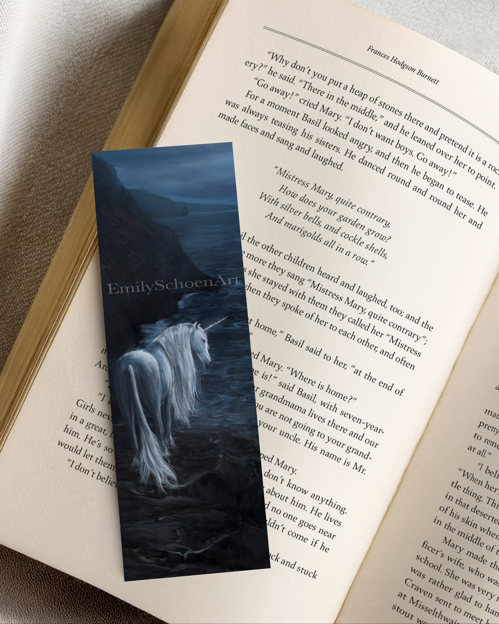 Book with a bookmark featuring a unicorn illustration on an open book